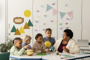 woman teaching kids about planets